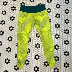 Brooks med rise 7/8ths length running tights. Green and neon yellow. Size S/M.